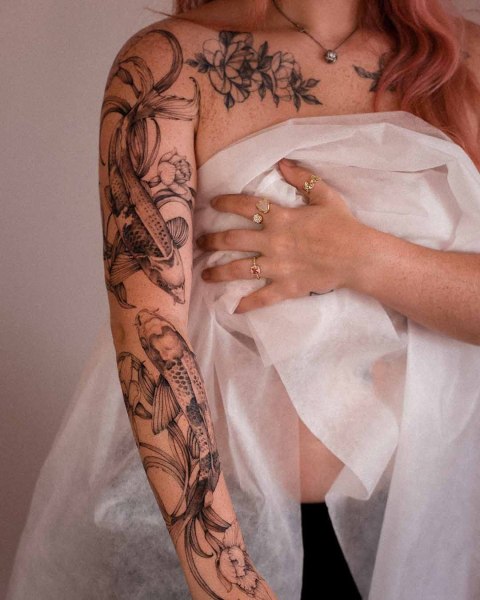 Fine line koi fish tattoo by Dominika at Silent Moon, our private tattoo studio in Bermondsey, South East London.
