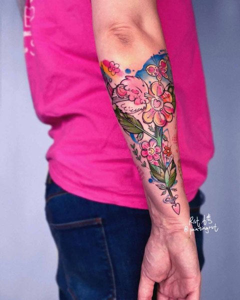 Colourful watercolour flower and butterfly forearm tattoo by guest artist Peng at Silent Moon, our private tattoo studio in Bermondsey, South East London.