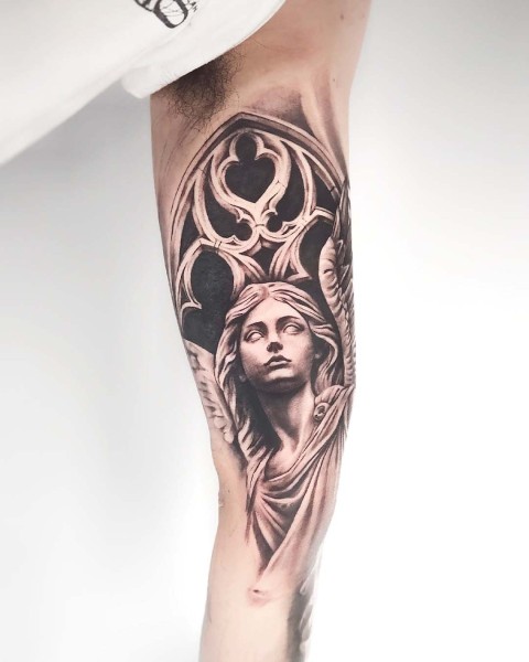 Black and grey realism angel statue tattoo by Klaudia at Silent Moon, our private tattoo studio in Bermondsey, South East London.