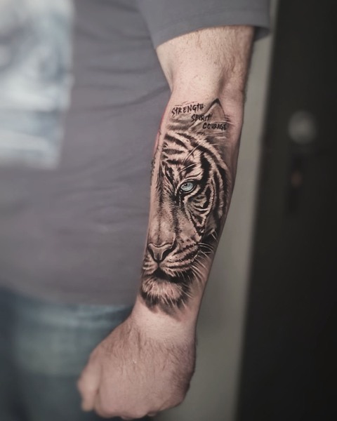 Black and grey realism half-face tiger tattoo by Klaudia at Silent Moon, our private tattoo studio in Bermondsey, South East London.