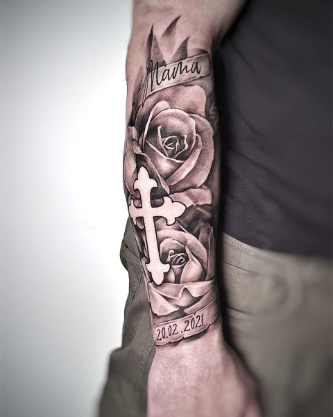 Black and grey realism memorial tattoo with roses and a cross by Klaudia at Silent Moon, our private tattoo studio in Bermondsey, South East London.