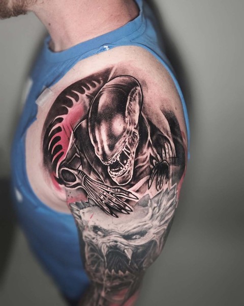 Black and grey realism sci-fi alien tattoo with red accents by Klaudia at Silent Moon, our private tattoo studio in Bermondsey, South East London.