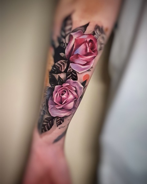 Colour realism pink rose tattoo by Klaudia at Silent Moon, our private tattoo studio in Bermondsey, South East London.
