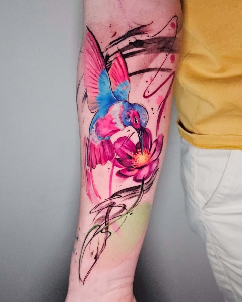 Colour realism hummingbird tattoo with watercolour brush strokes by Klaudia at Silent Moon, our private tattoo studio in Bermondsey, South East London.