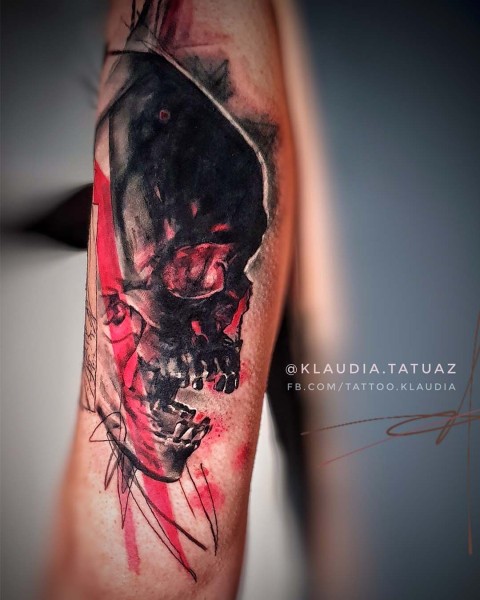 Realism skull tattoo in black and red, trash polka style, by Klaudia at Silent Moon, our private tattoo studio in Bermondsey, South East London.