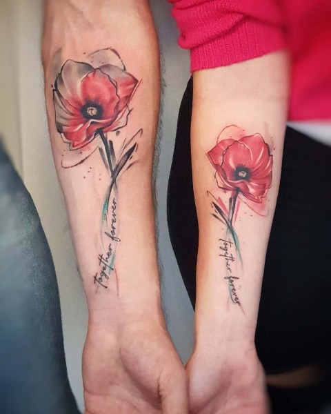 Matching watercolour poppy tattoos for a couple by Klaudia at Silent Moon, our private tattoo studio in Bermondsey, South East London.