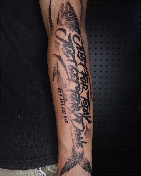 Calligraphy lettering fish forearm tattoo by Satrxx at Silent Moon, our private tattoo studio in Bermondsey, South East London.