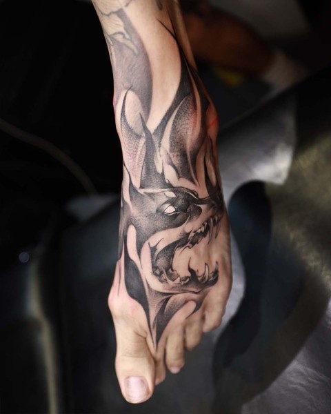 Black and grey demon wolf foot tattoo by Satrxx at Silent Moon, our private tattoo studio in Bermondsey, South East London.
