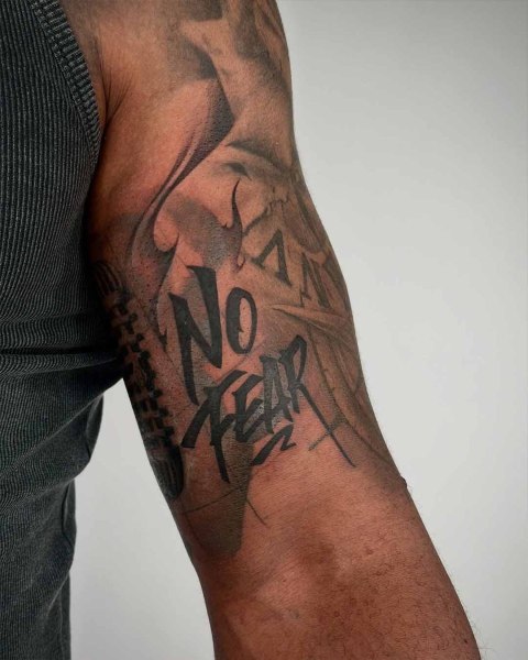 No Fear brush lettering tattoo by Satrxx at Silent Moon, our private tattoo studio in Bermondsey, South East London.