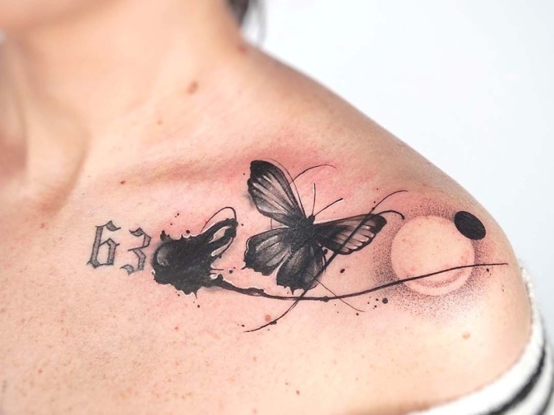 Abstract black ink butterfly tattoo on the collarbone by Klaudia at Silent Moon, our private tattoo studio in Bermondsey, South East London.