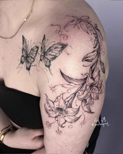 Black and grey butterflies and lilies shoulder tattoo by guest artist Peng at Silent Moon, our private tattoo studio in Bermondsey, South East London.
