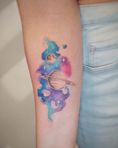 Watercolour galaxy tattoo with Saturn and the moon by Klaudia at Silent Moon, our private tattoo studio in Bermondsey, South East London.