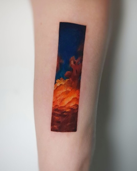 Watercolour painterly sunset sky tattoo by Klaudia at Silent Moon, our private tattoo studio in Bermondsey, South East London.