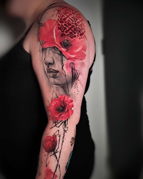 Watercolour red poppy sleeve tattoo with a woman's face by Klaudia at Silent Moon, our private tattoo studio in Bermondsey, South East London.