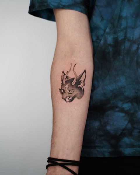 Small third eye cat forearm tattoo by Satrxx at Silent Moon, our private tattoo studio in Bermondsey, South East London.