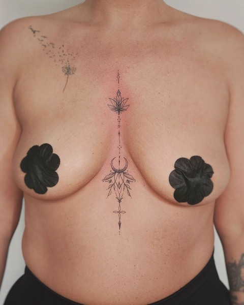 Fine line lotus and crescent moon sternum tattoo by Klaudia at Silent Moon, our private tattoo studio in Bermondsey, South East London.