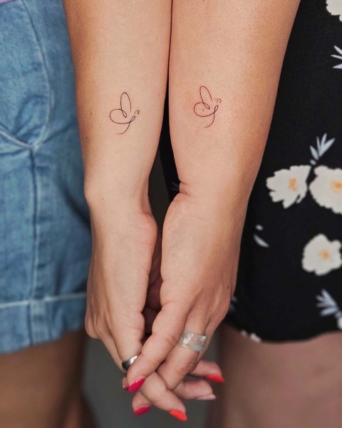 Matching fine line butterfly tattoos by Klaudia at Silent Moon, our private tattoo studio in Bermondsey, South East London.