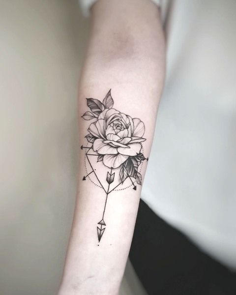 Fine line rose and geometric arrow tattoo by Klaudia at Silent Moon, our private tattoo studio in Bermondsey, South East London.