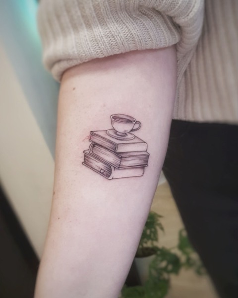 Fine line stack of books and teacup tattoo by Klaudia at Silent Moon, our private tattoo studio in Bermondsey, South East London.