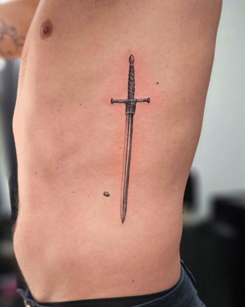Micro-realism sword tattoo by Klaudia at Silent Moon, our private tattoo studio in Bermondsey, South East London.