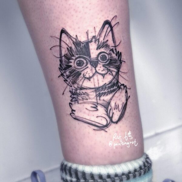 Abstract sketch blackwork tattoo on the lower leg of a whimsical cat portrait rendered in freehand lines and high-contrast shading. Custom pet portrait piece tattooed at Silent Moon Tattoo Studio in London