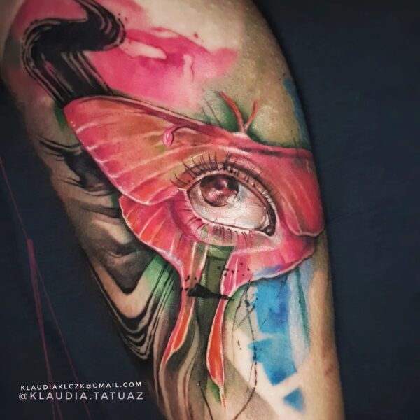 Abstract Eye and Butterfly Tattoo in Watercolour Style | Silent Moon Tattoo Studio London Abstract colour realism tattoo of an eye blended with butterfly wings and watercolor effects by tattoo artist at Silent Moon Tattoo Studio in London.