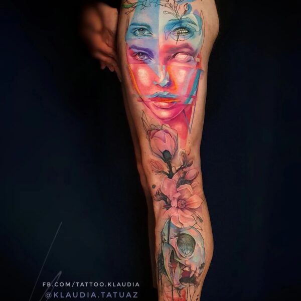 Vibrant Abstract Colour Leg Sleeve Tattoo | Portrait & Skull Art London Full leg sleeve tattoo in hyper-vibrant abstract colour featuring a split face portrait (blue/red), magnolia flowers, and a skull. Custom large-scale abstract realism piece tattooed at Silent Moon Tattoo Studio in London.