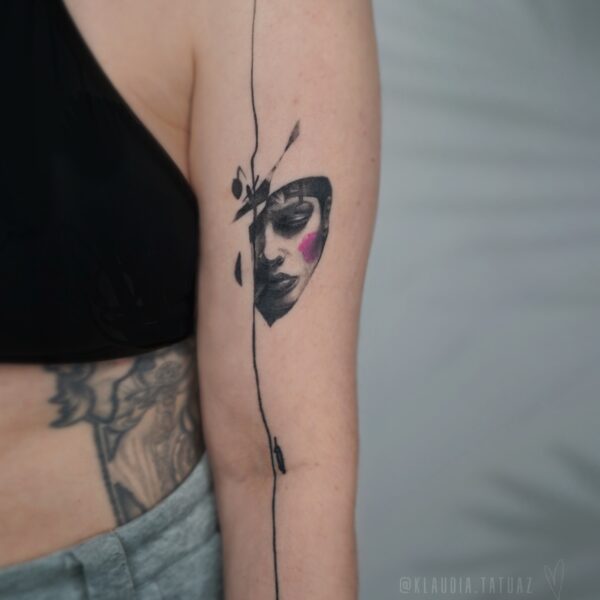 Abstract Portrait Tattoo with Pink Detail | Silent Moon Tattoo Studio London Abstract black and grey portrait tattoo with pink accent on upper arm by tattoo artist at Silent Moon Tattoo Studio in London
