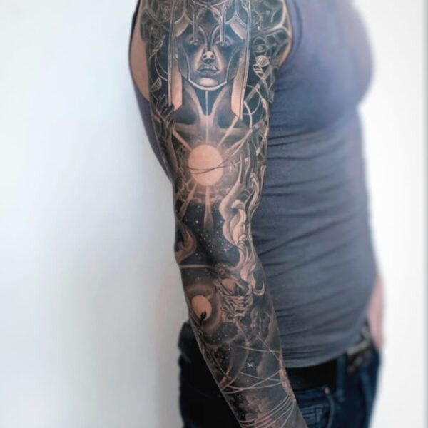 Full sleeve tattoo with cosmic goddess and geometric design in black and grey by tattoo artist at Silent Moon Tattoo Studio in London