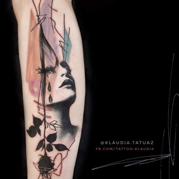 Abstract Realism Portrait & Cityscape Tattoo | Graphic Blackwork | Silent Moon London Abstract realism woman's face tattoo with cityscape, rain cloud, and Bird of Paradise flower. Graphic blackwork and turquoise accent tattooed at Silent Moon Tattoo Studio London UK.