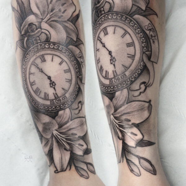 Black and grey pocket watch tattoo with flowers on forearm by tattoo artist at Silent Moon Tattoo Studio in London.