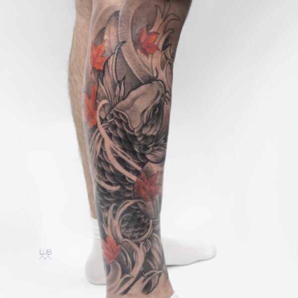 Japanese koi fish leg tattoo with red maple leaves and wave design by tattoo artist at Silent Moon Tattoo Studio in London
