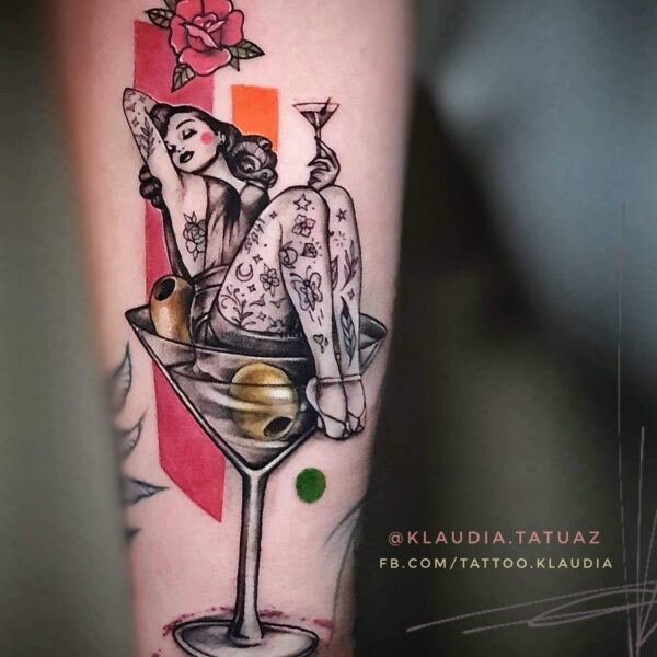 Neo-Traditional Pin-Up Martini Tattoo | Classic & Cocktails | Silent Moon London Neo-Traditional pin-up girl tattoo inside a martini glass with olives and a red rose. Blackwork figure with colour accents tattooed at Silent Moon Tattoo Studio London.