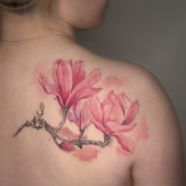 Watercolour Magnolia Flower Shoulder Tattoo | Silent Moon Tattoo Studio London Watercolour magnolia flower tattoo on shoulder blade by tattoo artist at Silent Moon Tattoo Studio in London.